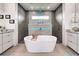 Contemporary bathroom featuring a freestanding tub, dual sinks, and tiled shower at 19 Windward Rd, Placida, FL 33946