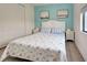 Comfortable bedroom featuring a queen bed, beach-themed decor, and ample natural light at 19 Windward Rd, Placida, FL 33946