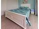Bedroom with blue accent wall, coastal décor, white trim, and wood-look flooring at 19 Windward Rd, Placida, FL 33946