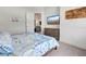 Bedroom with television, accent wall, light floors, and access to other living spaces at 19 Windward Rd, Placida, FL 33946