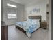 Bright bedroom with nautical themed decor, light wood-look floors, and a large window at 19 Windward Rd, Placida, FL 33946