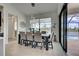Dining room featuring a modern table, chairs, and views of the pool at 19 Windward Rd, Placida, FL 33946