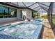 Back yard view of the hot tub and lounge chairs on the bricked deck at 19 Windward Rd, Placida, FL 33946