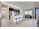 Modern kitchen with stainless steel appliances, island with seating, and adjacent dining area at 19 Windward Rd, Placida, FL 33946