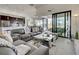 Open-concept living room with stylish furniture, kitchen view, and access to the screened lanai at 19 Windward Rd, Placida, FL 33946