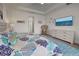 Spacious main bedroom with light walls, coastal accents, and an accent seagrass chair at 19 Windward Rd, Placida, FL 33946