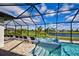 Screened-in pool and spa area overlooking the lawn and a waterway at 19 Windward Rd, Placida, FL 33946
