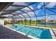 Enclosed pool area with clear blue water, a spa, and views of the lake and golf course at 19 Windward Rd, Placida, FL 33946