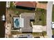 Aerial view of the property highlighting the private pool, backyard, and canal access with a dock at 1910 Greenlawn Dr, Englewood, FL 34223