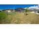 Spacious backyard with chain-link fence and lush lawn, perfect for outdoor activities at 1910 Greenlawn Dr, Englewood, FL 34223
