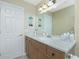 The bathroom offers a clean, bright space, featuring a large vanity with plenty of storage and counter space at 1910 Greenlawn Dr, Englewood, FL 34223