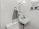 Bright bathroom featuring a toilet, sink, and a mirror on the wall at 1910 Greenlawn Dr, Englewood, FL 34223