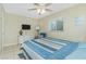 This comfortable bedroom features a comfy bed with coastal-themed decor, natural light, and relaxing ambiance at 1910 Greenlawn Dr, Englewood, FL 34223