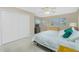 Comfortable bedroom featuring neutral colors, tile floor, ample closet space, and natural light at 1910 Greenlawn Dr, Englewood, FL 34223
