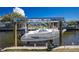 Featuring a sturdy boat lift, ideal for safely storing and maintaining your boat on the canal at 1910 Greenlawn Dr, Englewood, FL 34223