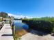 Public boat ramp with dock and lush vegetation for convenient water access at 1910 Greenlawn Dr, Englewood, FL 34223