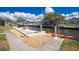 Waterfront property featuring dock with boat lifts, adjacent to a lush green lawn and mature trees at 1910 Greenlawn Dr, Englewood, FL 34223