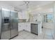 Bright kitchen featuring stainless steel appliances and white cabinetry at 1910 Greenlawn Dr, Englewood, FL 34223