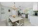 Open kitchen and dining area with stainless steel appliances and ample seating at 1910 Greenlawn Dr, Englewood, FL 34223