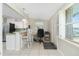 Bright kitchenette with bar seating, opening to outside patio at 1910 Greenlawn Dr, Englewood, FL 34223