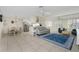 Open-concept living room with tile flooring, ceiling fans, and comfortable seating at 1910 Greenlawn Dr, Englewood, FL 34223