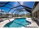 Relaxing screened-in pool area with waterfront views and comfortable seating; perfect for enjoying the Florida lifestyle at 1910 Greenlawn Dr, Englewood, FL 34223