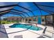 The covered pool area is perfect for year-round swimming and entertaining with comfortable seating at 1910 Greenlawn Dr, Englewood, FL 34223