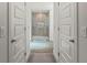 Bathroom with a glass shower and ceramic tile, light grey colored walls, and ceramic tile flooring at 23 Fairway Rd, Rotonda West, FL 33947