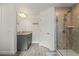 Modern bathroom with a gray vanity, granite countertop, and a glass-enclosed tiled shower at 23 Fairway Rd, Rotonda West, FL 33947