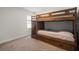 Bedroom with a wood bunkbed, carpet flooring, a window with blinds, and light grey colored walls at 23 Fairway Rd, Rotonda West, FL 33947