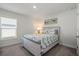 Bedroom featuring a bed, neutral colors and a window at 23 Fairway Rd, Rotonda West, FL 33947