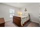 Bedroom with a wood bed, coastal themed bedding, a window with blinds, and light grey colored walls at 23 Fairway Rd, Rotonda West, FL 33947