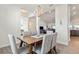 Dining area with a wooden table, gray upholstered chairs, and a modern chandelier above at 23 Fairway Rd, Rotonda West, FL 33947