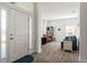 Bright foyer with wood-look tile flooring, a view into the living area, and a white front door at 23 Fairway Rd, Rotonda West, FL 33947