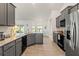 Modern kitchen features granite countertops, gray cabinets, and stainless steel appliances at 23 Fairway Rd, Rotonda West, FL 33947
