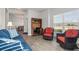 Comfortable living area featuring tile floors, a desk, and a view of the outdoors through large windows at 23 Fairway Rd, Rotonda West, FL 33947