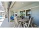 Outdoor patio featuring a table with seating, a retractable awning, and access to the pool area at 23 Fairway Rd, Rotonda West, FL 33947
