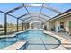 Inviting screened pool and spa area with clear blue water and outdoor seating at 23 Fairway Rd, Rotonda West, FL 33947