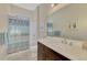 Bright bathroom with a shower/tub combo, single vanity with dark wood cabinets, and modern fixtures at 26636 Irwin Dr, Englewood, FL 34223