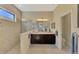 Modern bathroom featuring a glass-enclosed shower, double vanity, neutral color palette, and tile flooring at 26636 Irwin Dr, Englewood, FL 34223