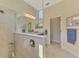 Modern bathroom with a glass shower enclosure, double vanity, tile flooring, and updated fixtures at 26636 Irwin Dr, Englewood, FL 34223