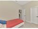 Simple bedroom with a single bed, neutral walls, carpeted floor, and ample natural light at 26636 Irwin Dr, Englewood, FL 34223