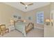 Charming bedroom with a spindle bed, shuttered window, neutral decor, and ample natural light at 26636 Irwin Dr, Englewood, FL 34223