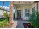 Welcoming front entrance with elegant stone accents and cozy seating at 26636 Irwin Dr, Englewood, FL 34223
