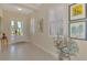 Bright foyer featuring tile floors, plantation shutters and beautiful decor at 26636 Irwin Dr, Englewood, FL 34223