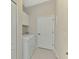 Functional laundry room with a modern washer and dryer, white cabinets, and a clean, well-lit space at 26636 Irwin Dr, Englewood, FL 34223