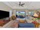 Comfortable living room with large windows providing lots of natural light and a view to the lanai at 26636 Irwin Dr, Englewood, FL 34223
