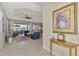 Open-concept living area with a ceiling fan and outdoor patio access at 26636 Irwin Dr, Englewood, FL 34223
