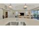 Open-concept living room with modern lighting, tray ceilings and sliding barn door at 26636 Irwin Dr, Englewood, FL 34223