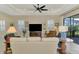 Bright living room with white plantation shutters, comfortable seating and sliding door access to the lanai at 26636 Irwin Dr, Englewood, FL 34223